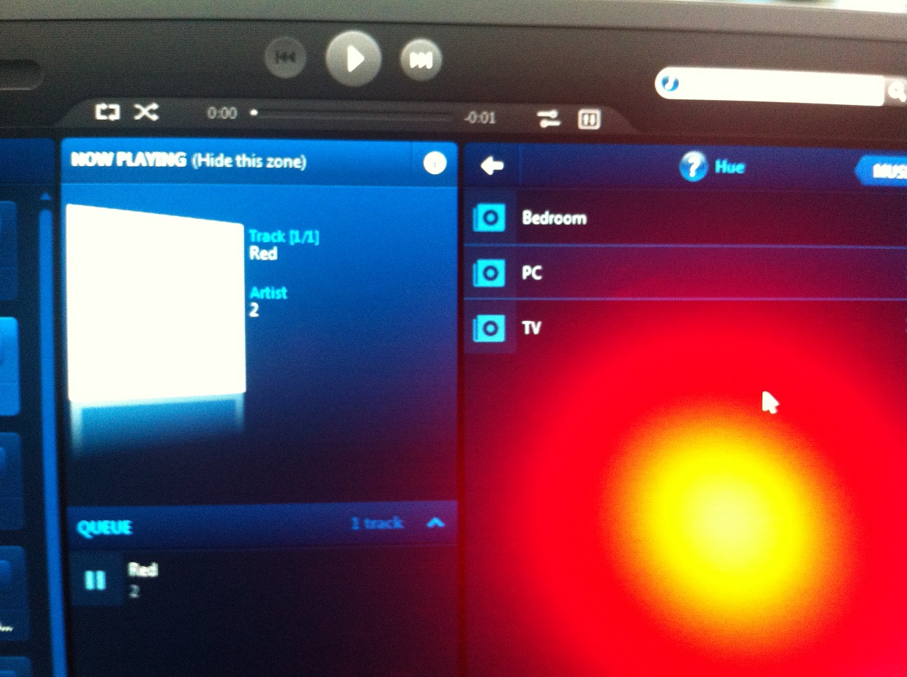 My Sonos Desktop Controller with the reflection of a Hue light